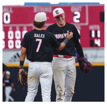 Two baseball players wearing black shirts and white pants are standing on a field. AI generated content
