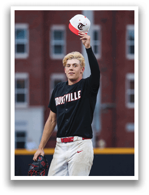 A baseball player wearing a black jersey with the word “Ville" on it holds a red hat in his hand. AI generated content