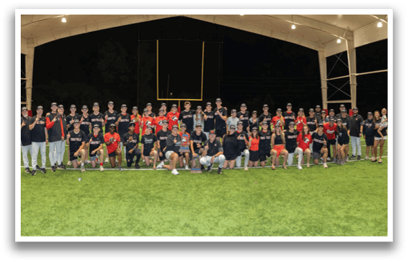 A group of people posing for a photo on a field. AI generated content