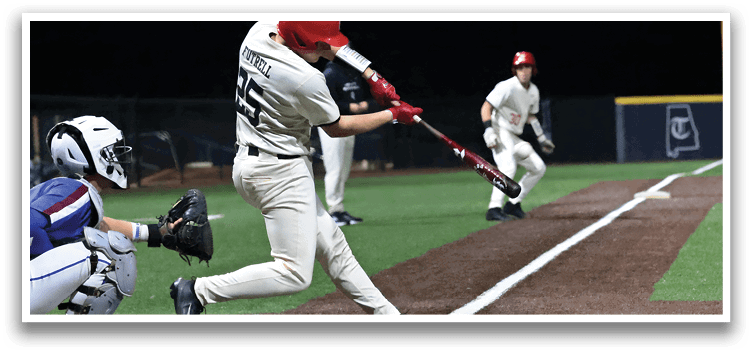 A baseball player in a red helmet and white uniform is swinging a bat at a ball. AI generated content