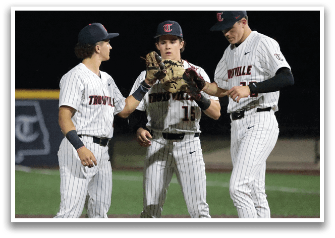 Three baseball players from the same team are standing together on the field, wearing their uniforms. One of the players is holding a baseball glove. AI generated content