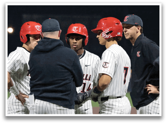 A group of baseball players wearing red hats and white uniforms are standing together on a field. AI generated content