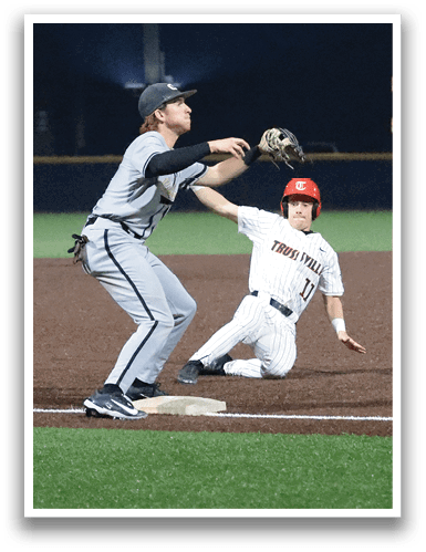 A baseball player slides into a base while another player tries to catch the ball. AI generated content