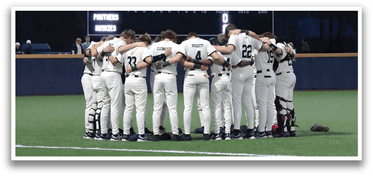 Baseball players huddled together on the field, wearing white uniforms. AI generated content