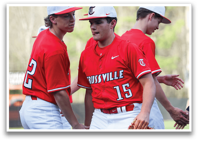 A group of baseball players wearing red jerseys and white pants are standing on a field. AI generated content