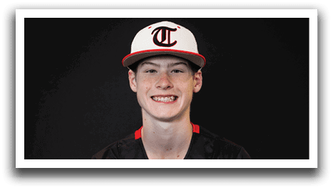 A young man wearing a black and white baseball uniform with the word “Huskies" on the front. AI generated content