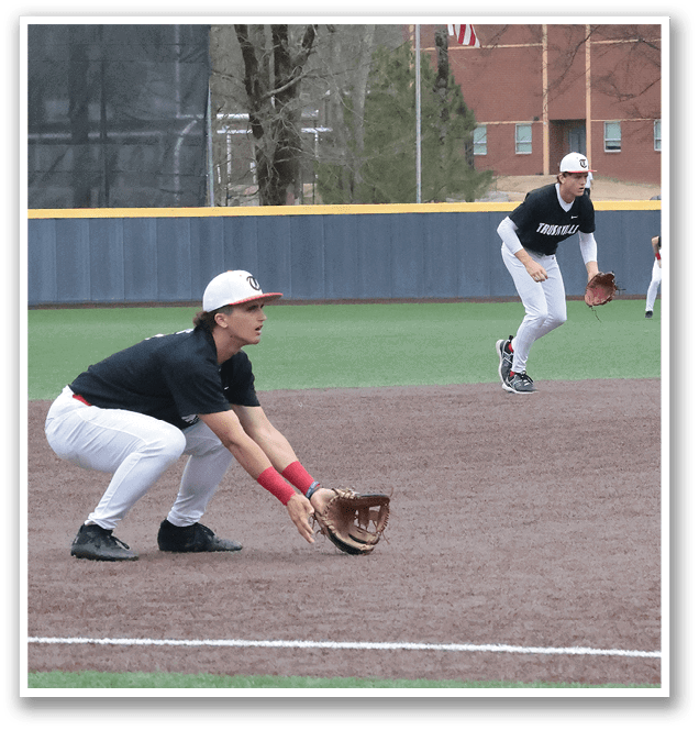A baseball player is kneeling on the ground with his glove on, ready to catch the ball. AI generated content