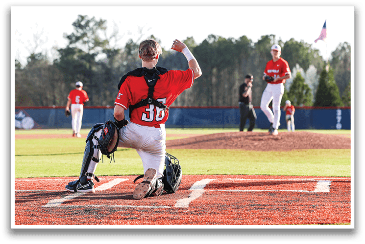 A baseball player in a red shirt is holding his arm up in the air. AI generated content