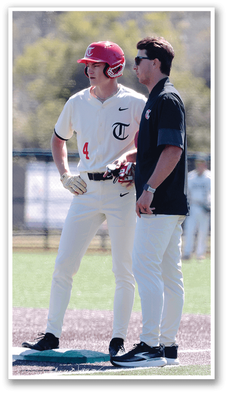 Two men wearing baseball uniforms are standing on a field, talking to each other. AI generated content