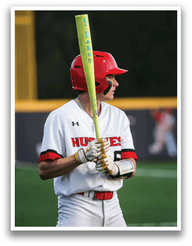 A baseball player in a red helmet and white uniform holding a bat. AI generated content
