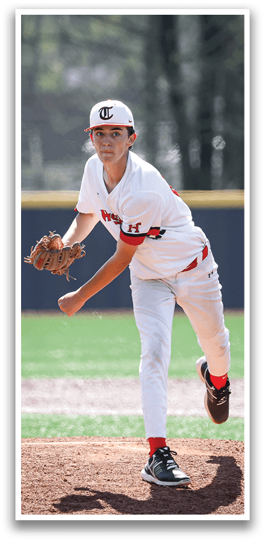 A baseball player in a white uniform is pitching a ball on a field. AI generated content