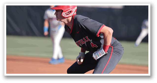 A baseball player wearing a red helmet and a grey jersey is crouching down on the field. AI generated content