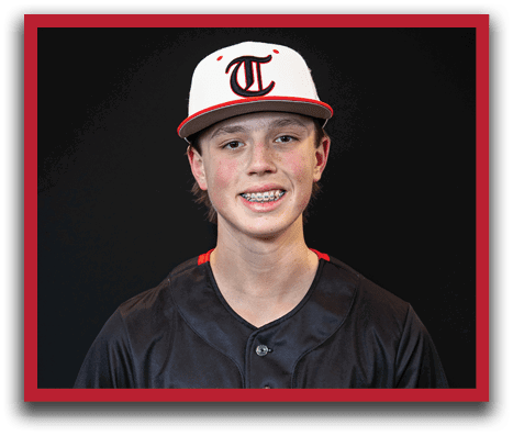 A young man wearing a black and red baseball jersey with the number 8 on it. AI generated content