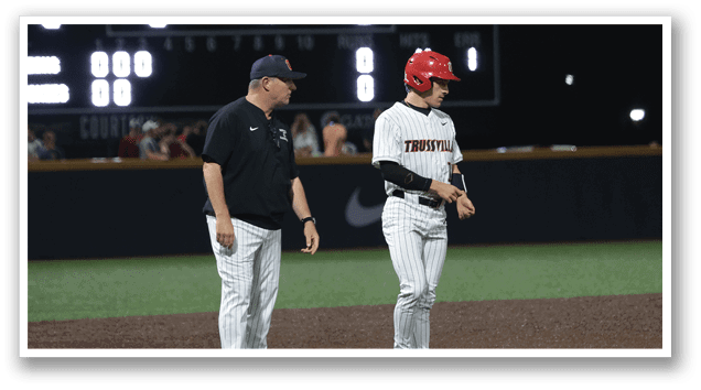 Two men are standing on a baseball field, one of them is wearing a red hat. AI generated content