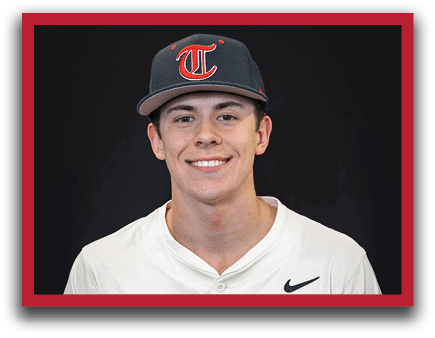 A young man wearing a baseball uniform and a blue hat with a T on it. AI generated content