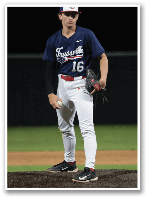 A baseball player in a blue and red uniform stands on a pitcher's mound, holding a baseball in his hand. AI generated content