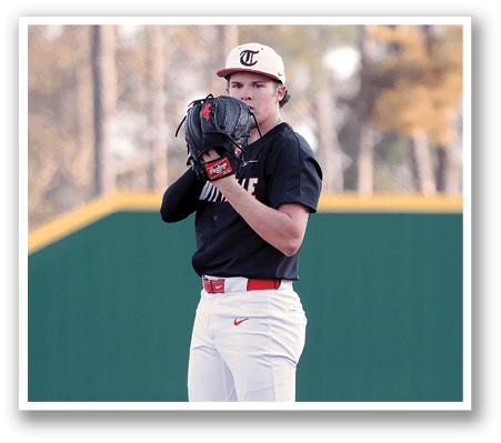 A baseball player in a black and red uniform stands on the pitcher's mound, holding a baseball glove. AI generated content