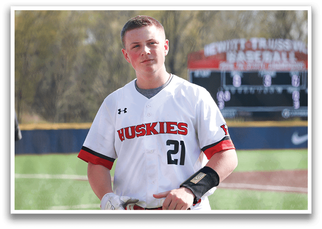 A baseball player wearing a white jersey with the number 2 on it stands on a field. AI generated content
