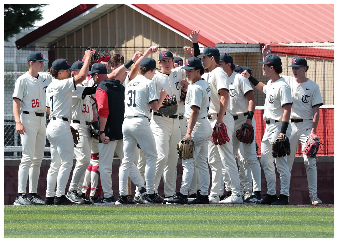 Baseball players huddled together on a field, some wearing red and white uniforms. AI generated content