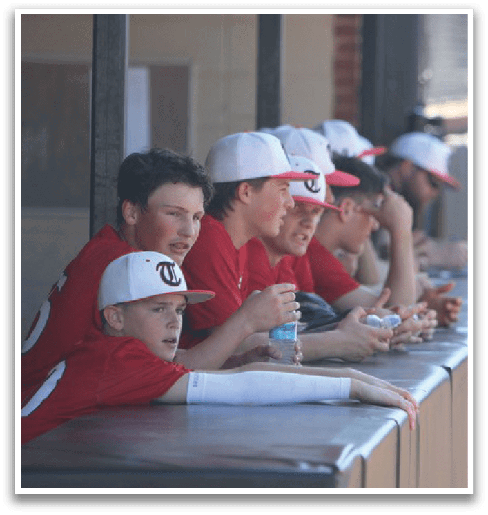 A group of young men wearing red shirts are sitting on a bench. AI generated content