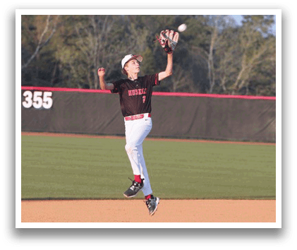 A baseball player in a black and red uniform is leaping in the air to catch a ball. AI generated content