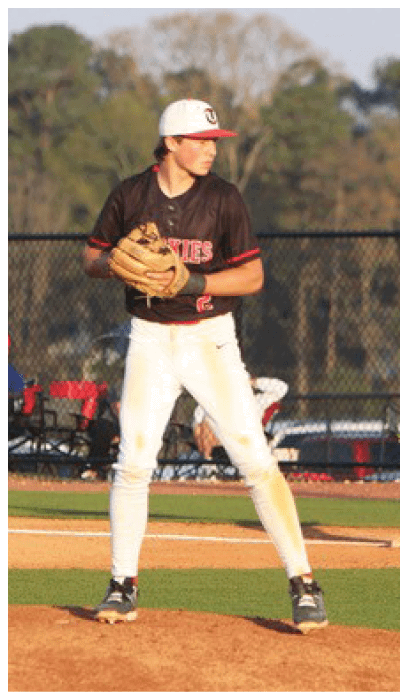 A baseball player in a black shirt and white pants is standing on a mound, holding a baseball glove. AI generated content