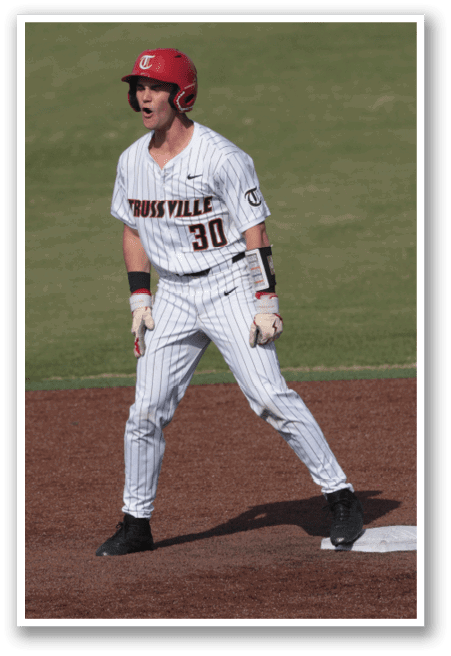 A baseball player wearing a red helmet and white uniform is walking across the field. AI generated content