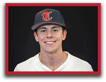 A young man wearing a baseball uniform and a cap with the letter T on it. AI generated content