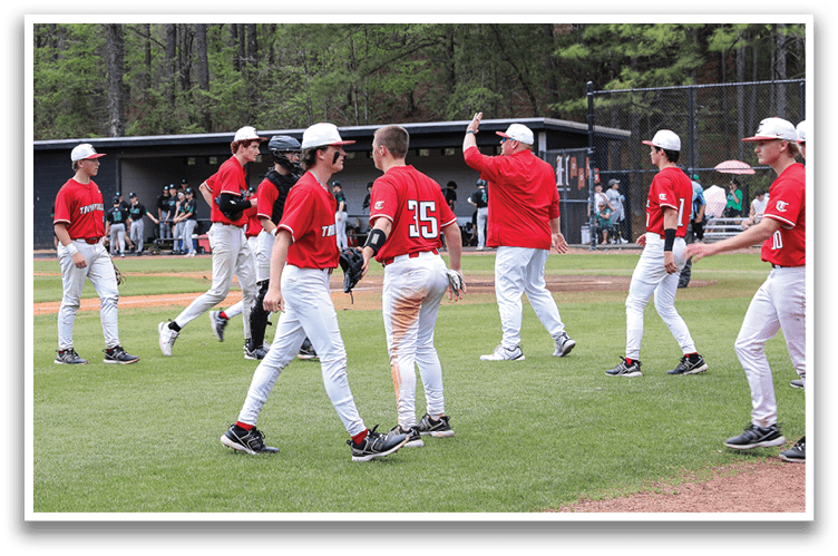 Baseball players in red uniforms are walking across a field. AI generated content