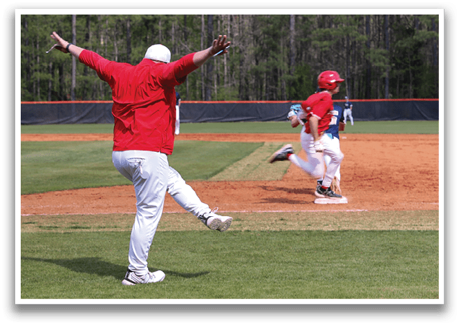 A baseball game is in progress with a man in a red shirt and white pants running towards home plate. AI generated content