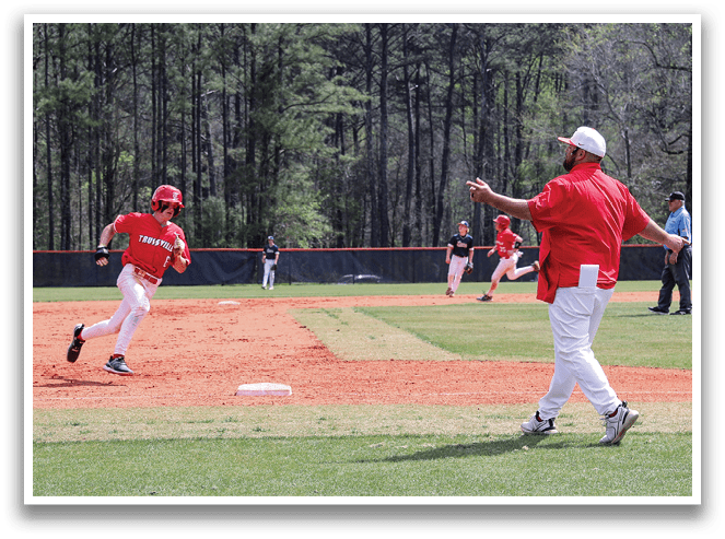 A baseball game is taking place with a man running to a base. AI generated content