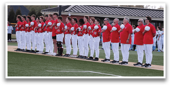 A group of people wearing red shirts and white pants stand on a field. AI generated content