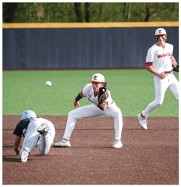 A baseball player catches a ball while another player runs to the base. AI generated content