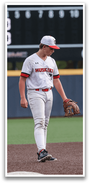 A baseball player wearing a white uniform and red hat stands on the field. AI generated content