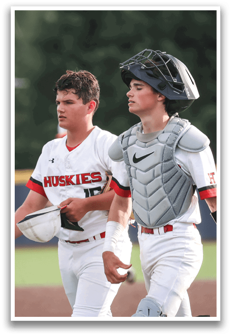 Three baseball players wearing white uniforms and helmets are walking on a field. AI generated content