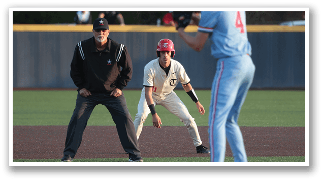 A baseball player in a blue shirt is holding a baseball bat, ready to swing. AI generated content