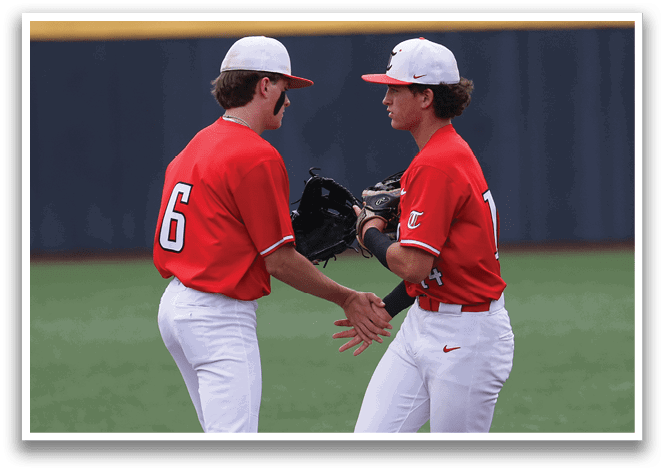 Two baseball players wearing red shirts and white pants are shaking hands on the field. AI generated content