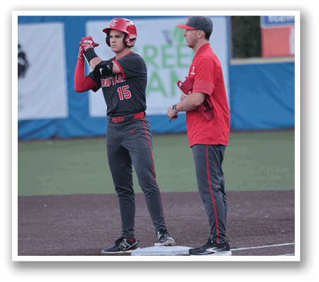 Two men are standing on a baseball field, one of them wearing a baseball helmet. AI generated content