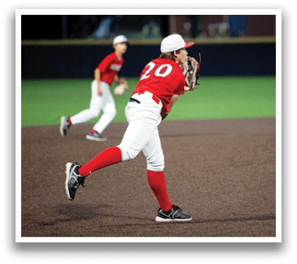 A boy in a red shirt is playing baseball, throwing a ball. Another boy is running behind him. AI generated content