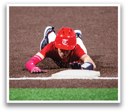 A baseball player is sliding into home base, wearing a red helmet and a red shirt. AI generated content