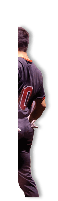 A baseball player wearing a black and red jersey stands on a field. AI generated content