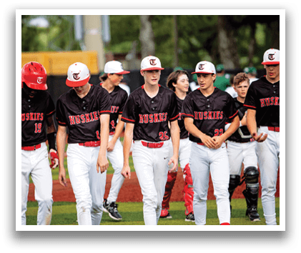 A group of baseball players wearing black and red uniforms are walking on a field. AI generated content