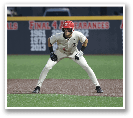 A baseball player wearing a red helmet and white uniform is standing on the field, ready to catch a ball. AI generated content