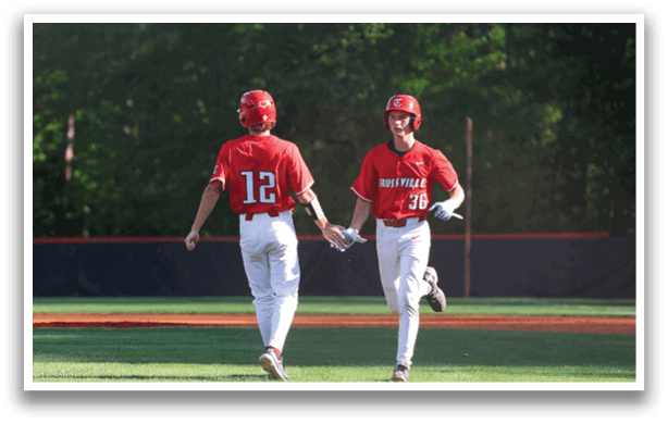 Two baseball players wearing red shirts and white pants are walking on the field. AI generated content