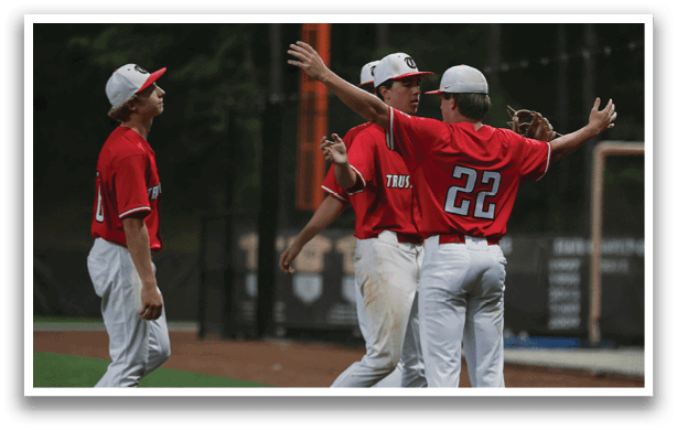 A group of young men in red shirts are standing on a baseball field. AI generated content