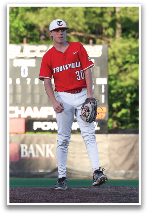 A baseball player in a red jersey and white pants stands on a pitcher's mound, holding a baseball glove. AI generated content