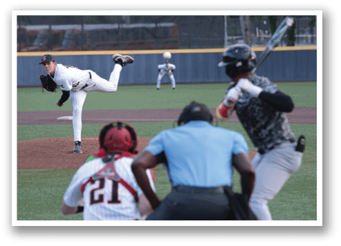 A baseball player in a white uniform is pitching a ball on a field. AI generated content