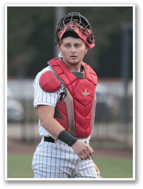 A baseball player wearing a red and white uniform and a red chest protector. AI generated content