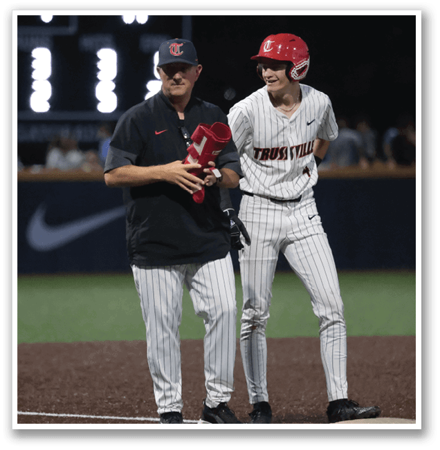 Two men are standing on a baseball field, one of them wearing a red helmet. AI generated content