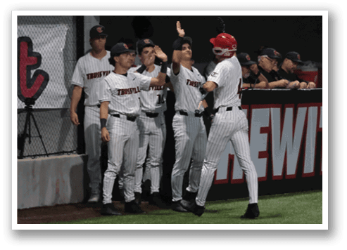 A group of baseball players are standing on the field, some of them wearing red hats. AI generated content